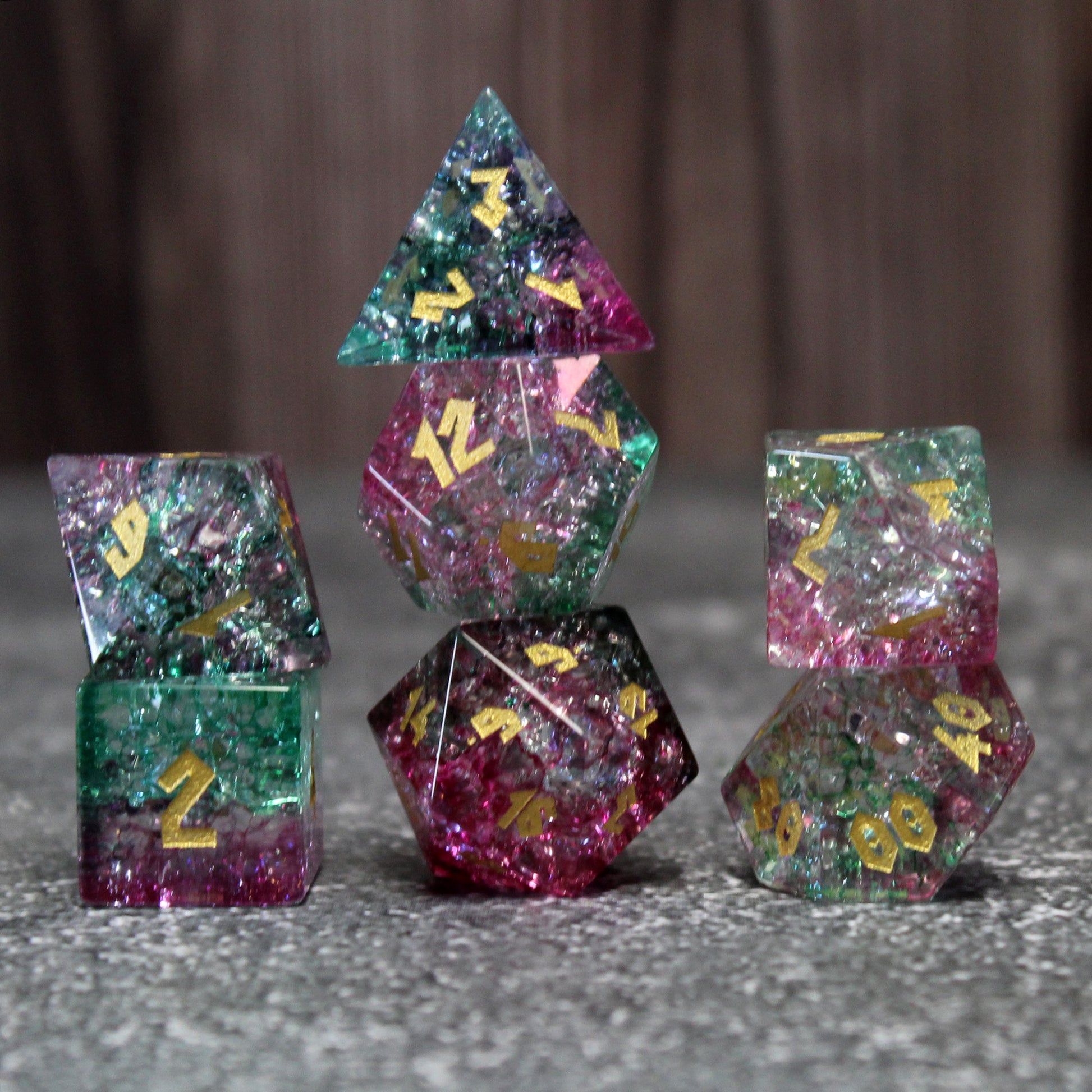 Fae Friend Shattered Glass dice set with a flamingo pink and emerald green design, perfect for enchanted campaigns and characters tied to the Fae.