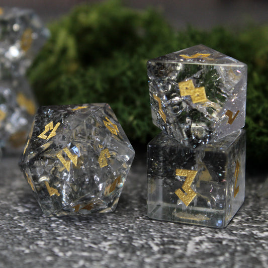 Close-up of the D20 die split between shimmering silver and deep black glass