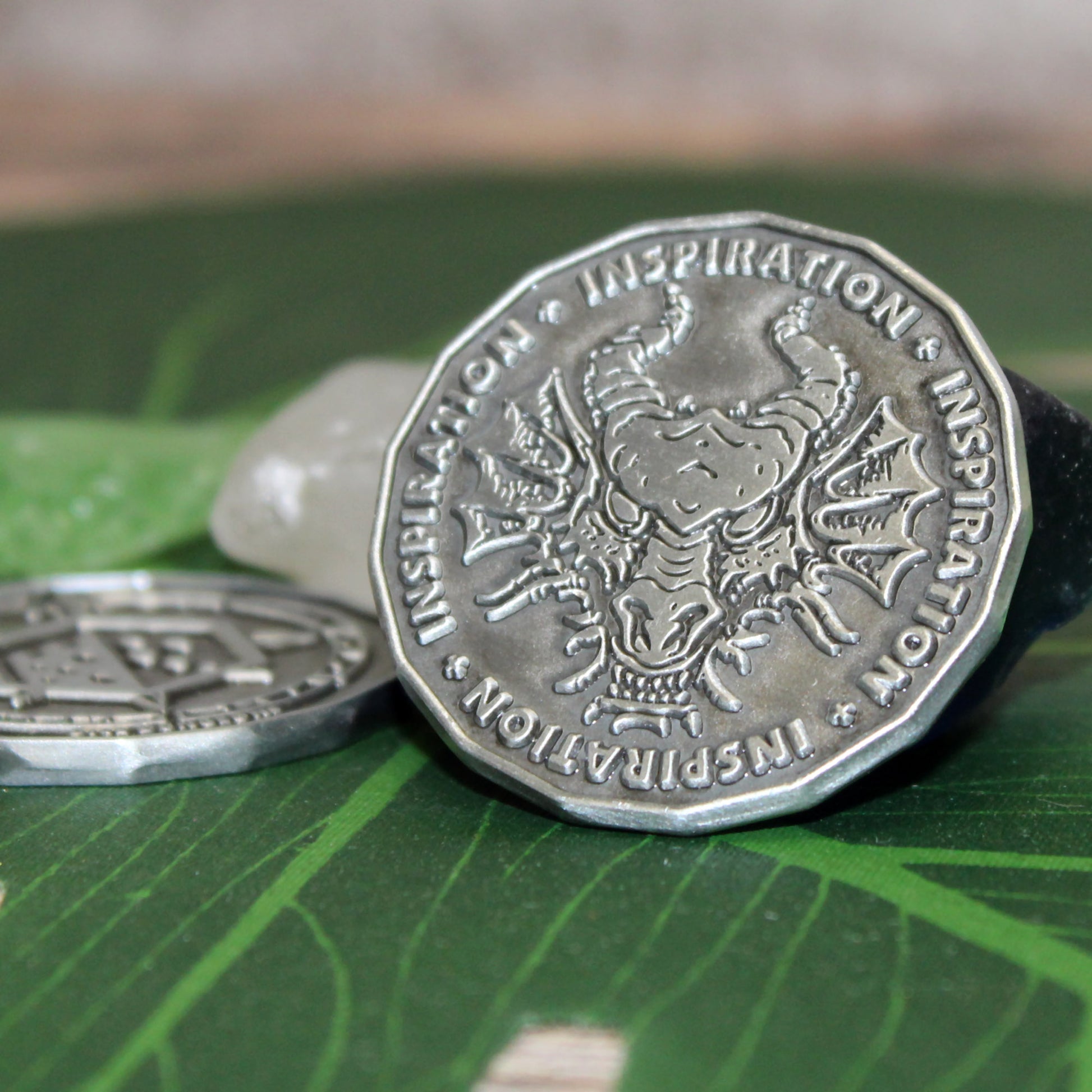 Antique silver inspiration coin to use for tracking heroic inspiration in dungeons and dragons games.