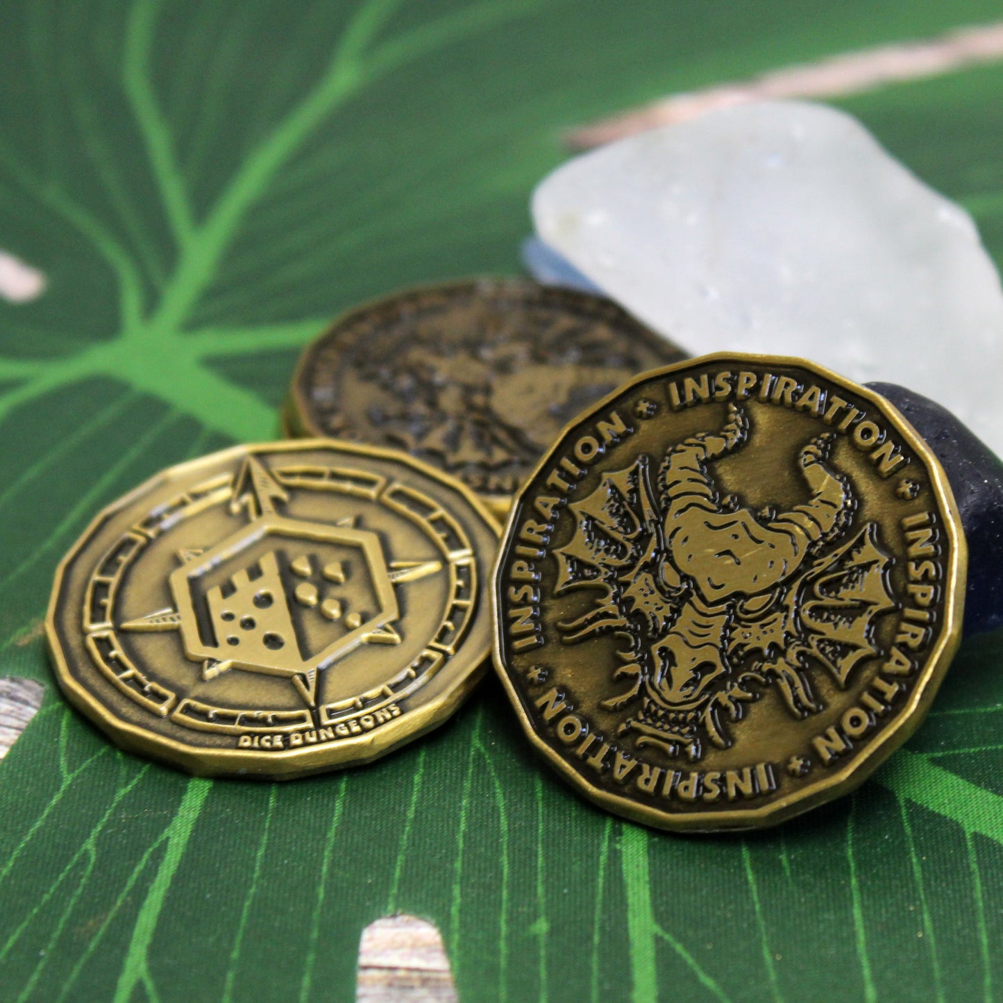 Metal tokens for tracking heroic inspiration in DnD games.