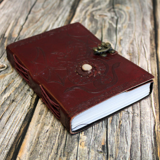Red leather Dungeons & Dragons journal featuring an embossed twin dragon design, perfect for tabletop RPG note-taking