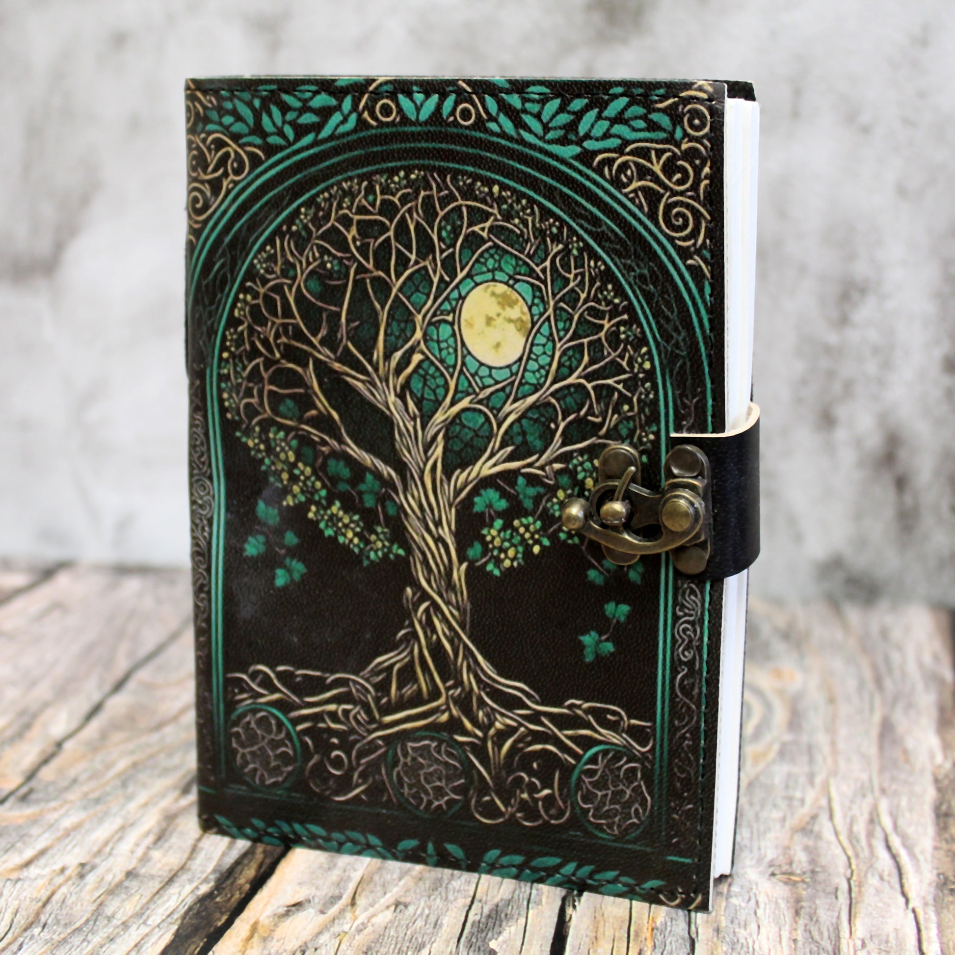 Green, gold, and black leather Dungeons & Dragons journal featuring an embossed world tree design for tabletop RPG note-taking
