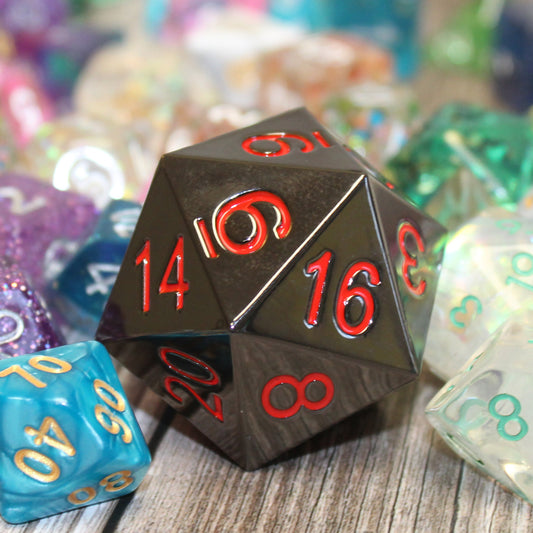 Jumbo 33mm Ember D20 Nested Among Standard-Sized Dice, Highlighting Its Size and Hefty Metal Build with Black Electroplated Finish.