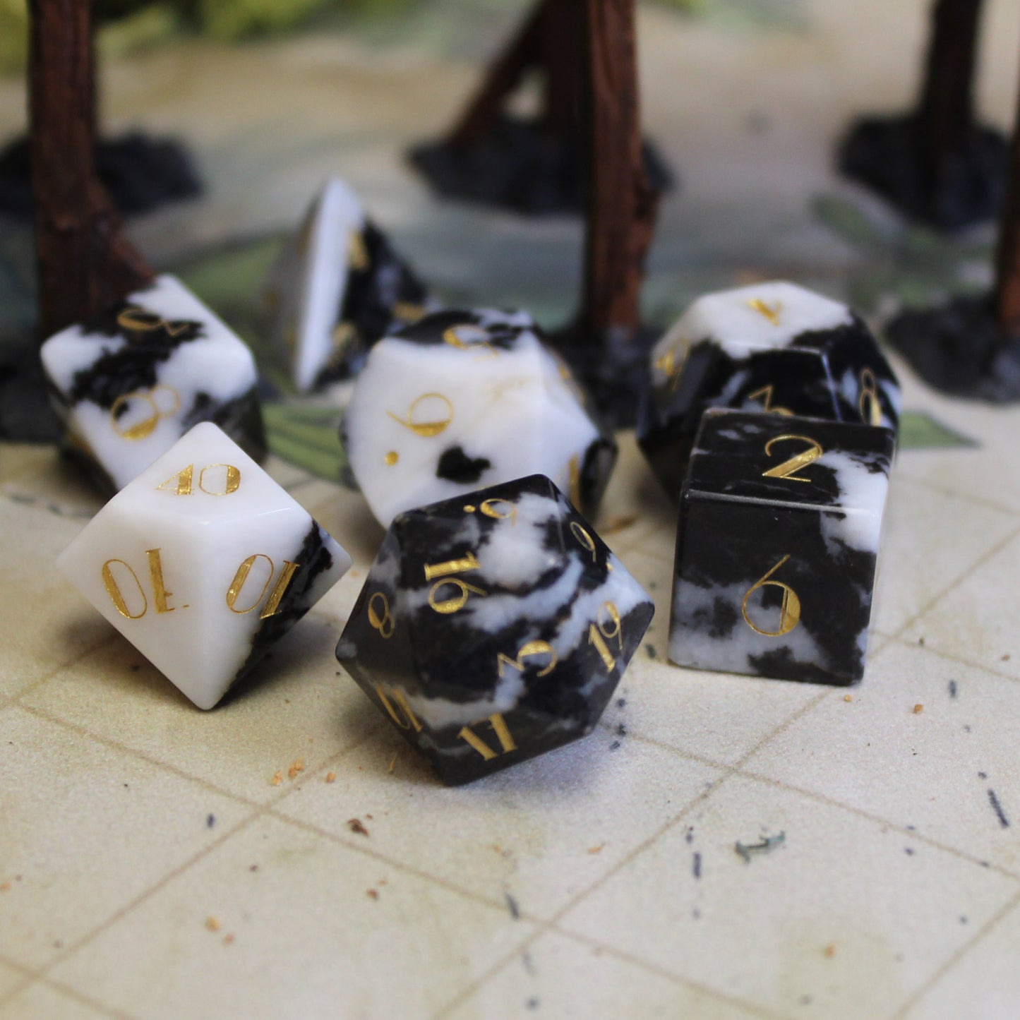 Milk Cow Jasper Gemstone Dice Set in use on a Dungeons & Dragons battlemap, combining the gemstone's striking black and white look with gameplay elegance.