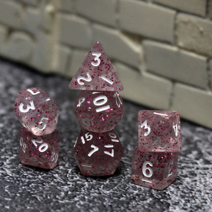 A set of Pink Glittery plastic dice in three stacks. 