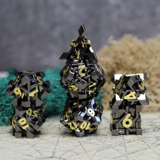 Full set of NightBane black metal dice arranged on a adventure map tabletop, showcasing the golden numbers that gleam on each die's intricate black design.