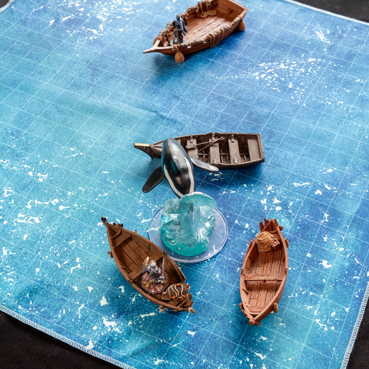 Isometric photo of an ocean battle map with boats and an orca miniature on it