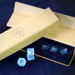 Set of seaglass blue dice with a decorative PU Leather Dice box on a dark background