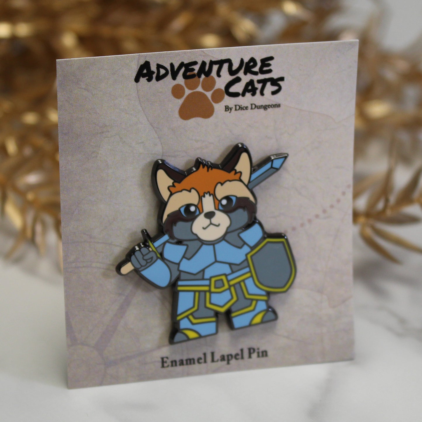 Adventure Cats paladin enamel pin shown with its illustrated backing card, highlighting the feline paladin holding a sword and shield