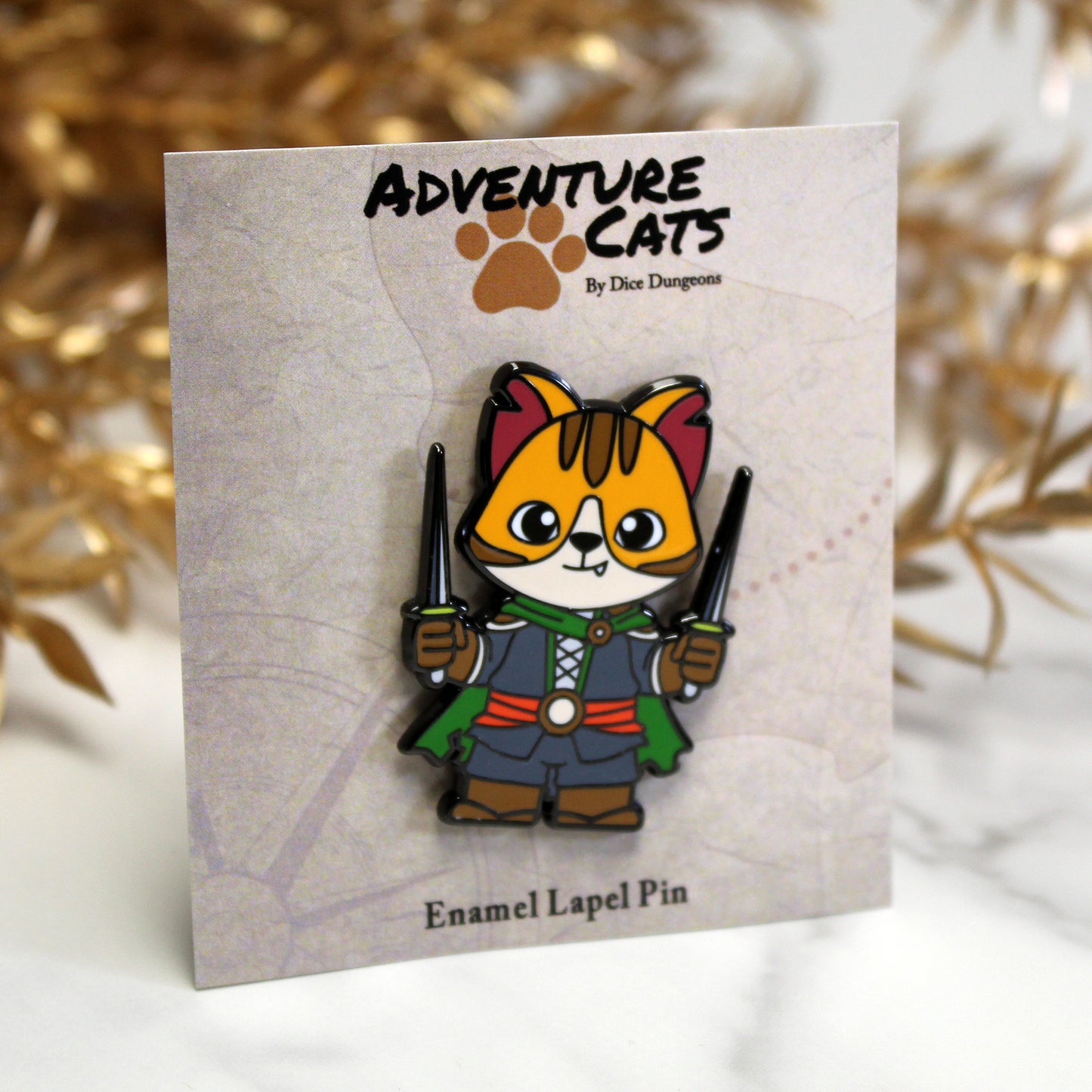 Adventure Cats rogue enamel pin shown with its illustrated backing card, highlighting the stealthy feline rogue with a dagger.