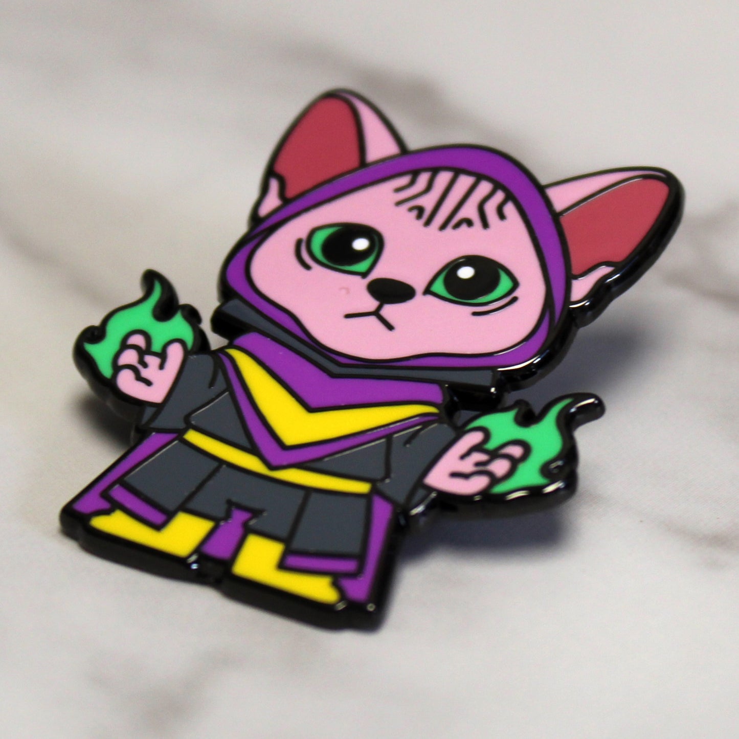 Adventure Cats warlock enamel pin featuring a hairless Sphinx cat casting a green magical spell, displayed against a plain white background.