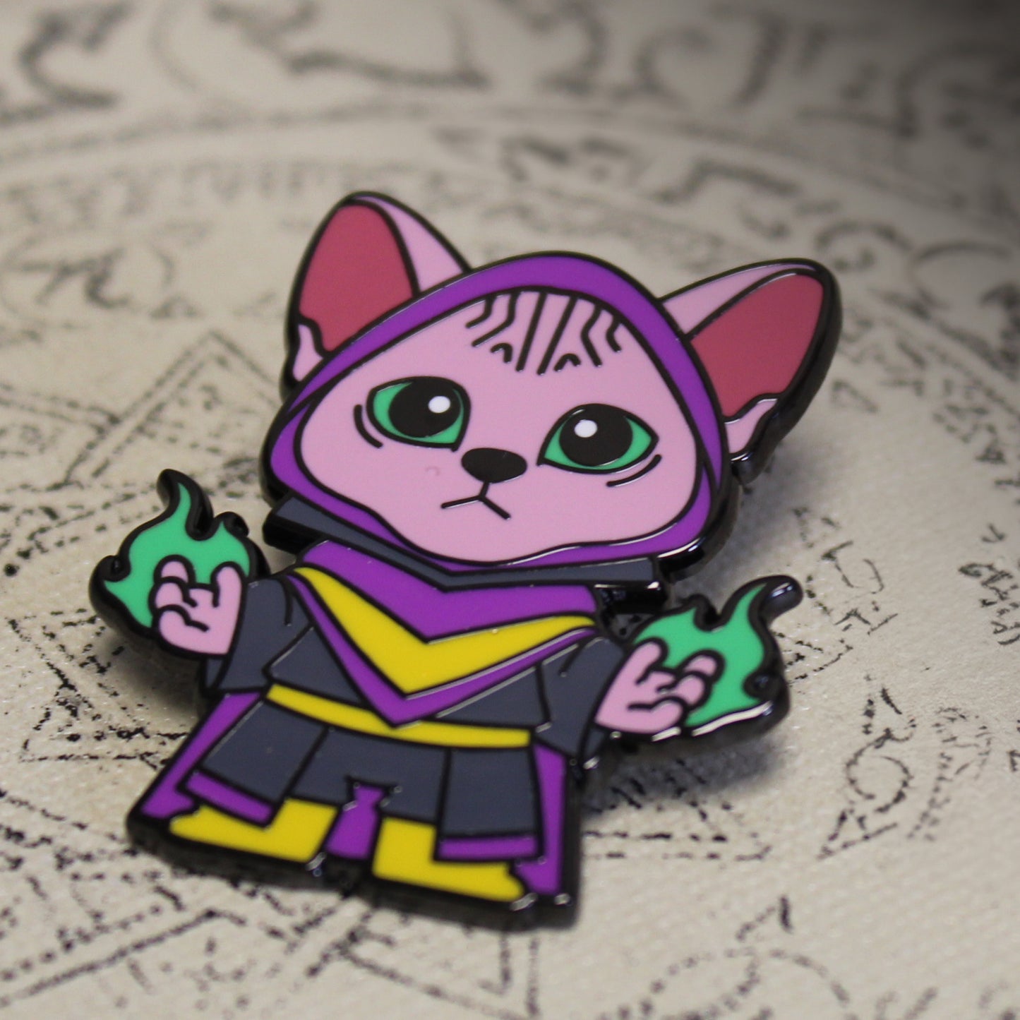 Adventure Cats warlock pin displayed on an aged scroll, enhancing the arcane theme with the Sphinx cat casting a green spell.