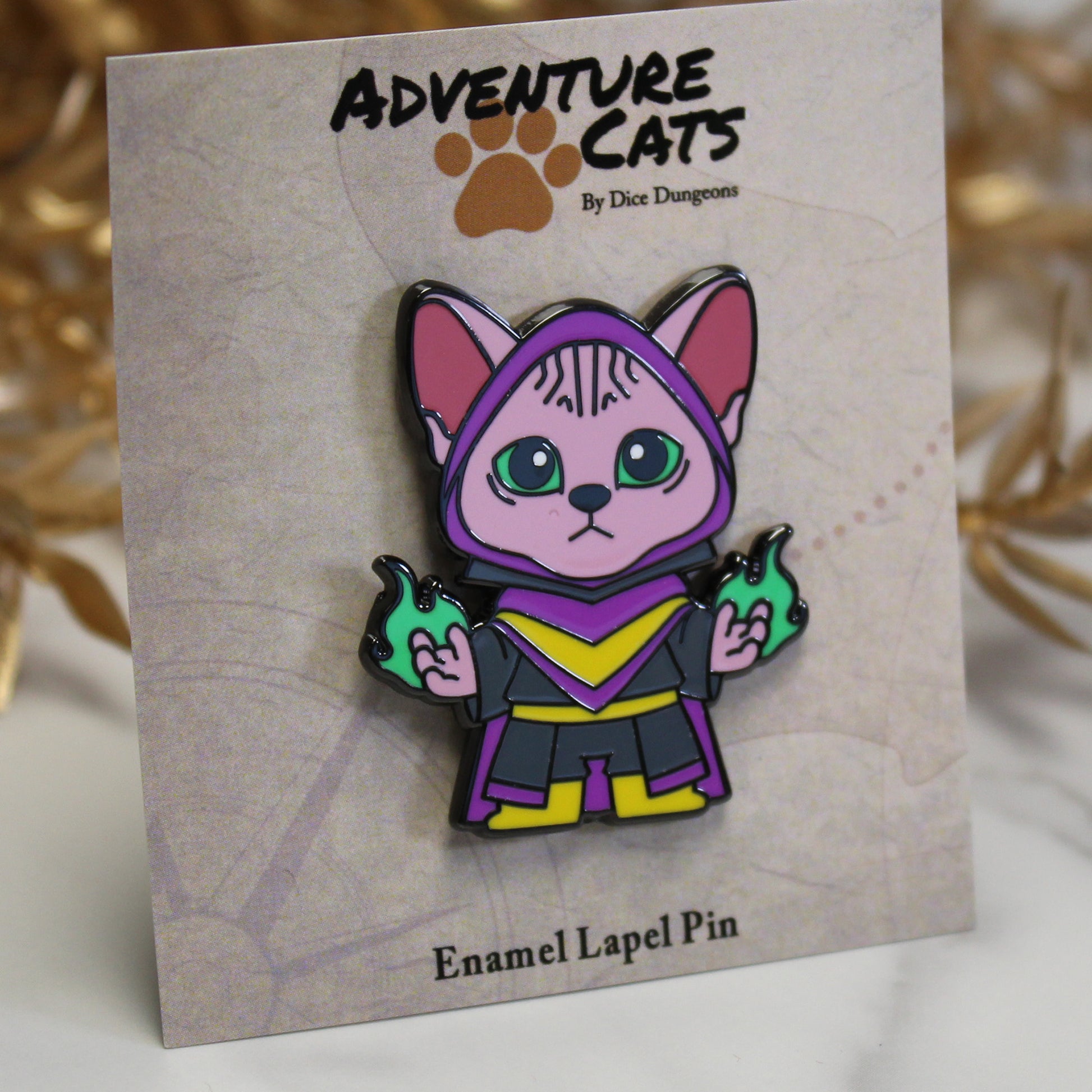 Adventure Cats warlock enamel pin with its illustrated backing card, highlighting the Sphinx cat warlock casting green magic.