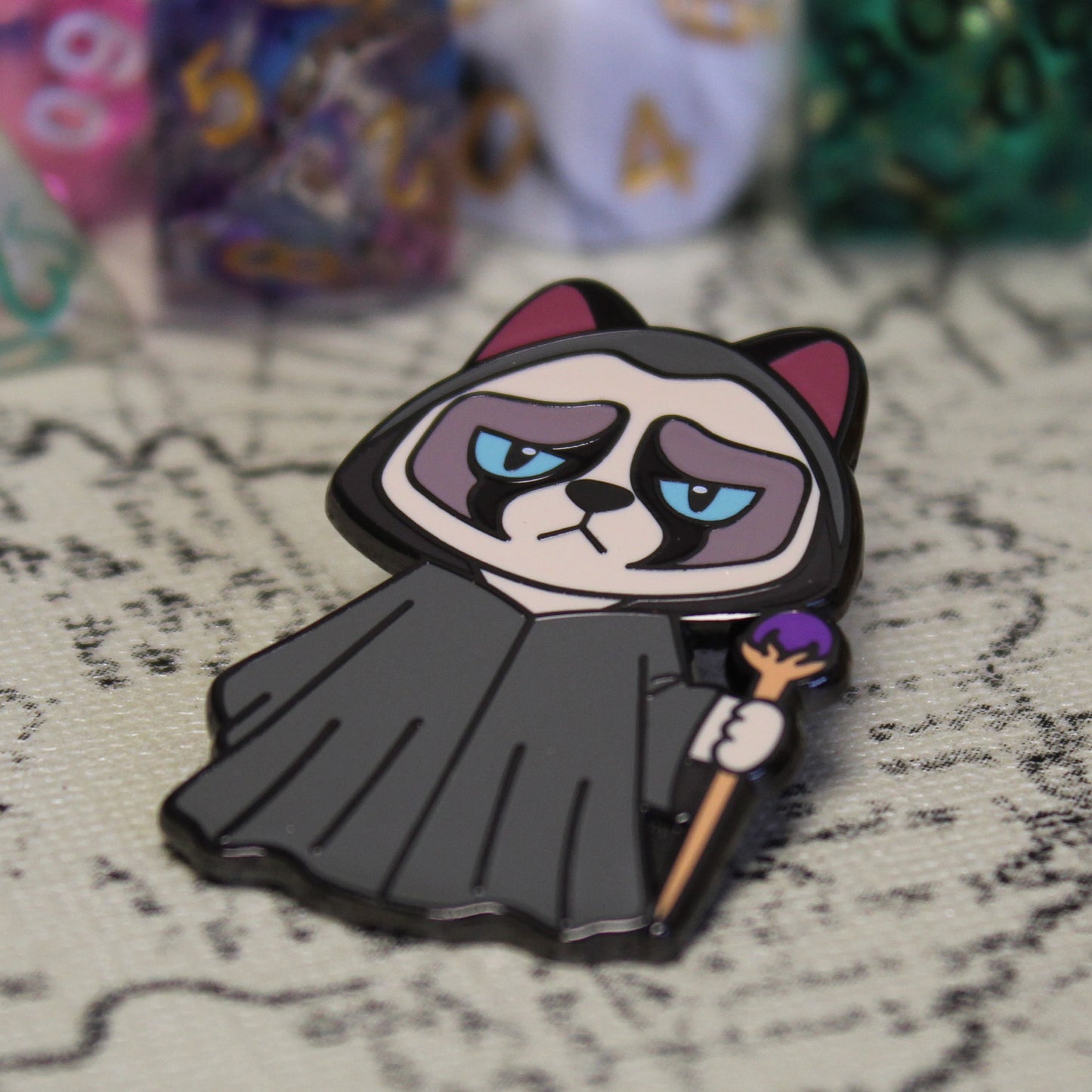 Adventure Cats wizard enamel pin displayed on a detailed adventure map, enhancing the fantasy and exploration theme.