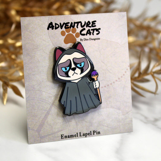 Adventure Cats wizard enamel pin displayed with its illustrated backing card, highlighting the grumpy feline wizard character.