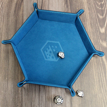 Blue Folding Hexagonal Dice Tray on a wooden background, with white polyhedral dice inside. Dice not included.