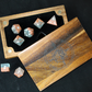Set of polyhedral dice with a wooden box on a black background