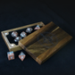 Wooden dice case with polyhedral dice on a dark background