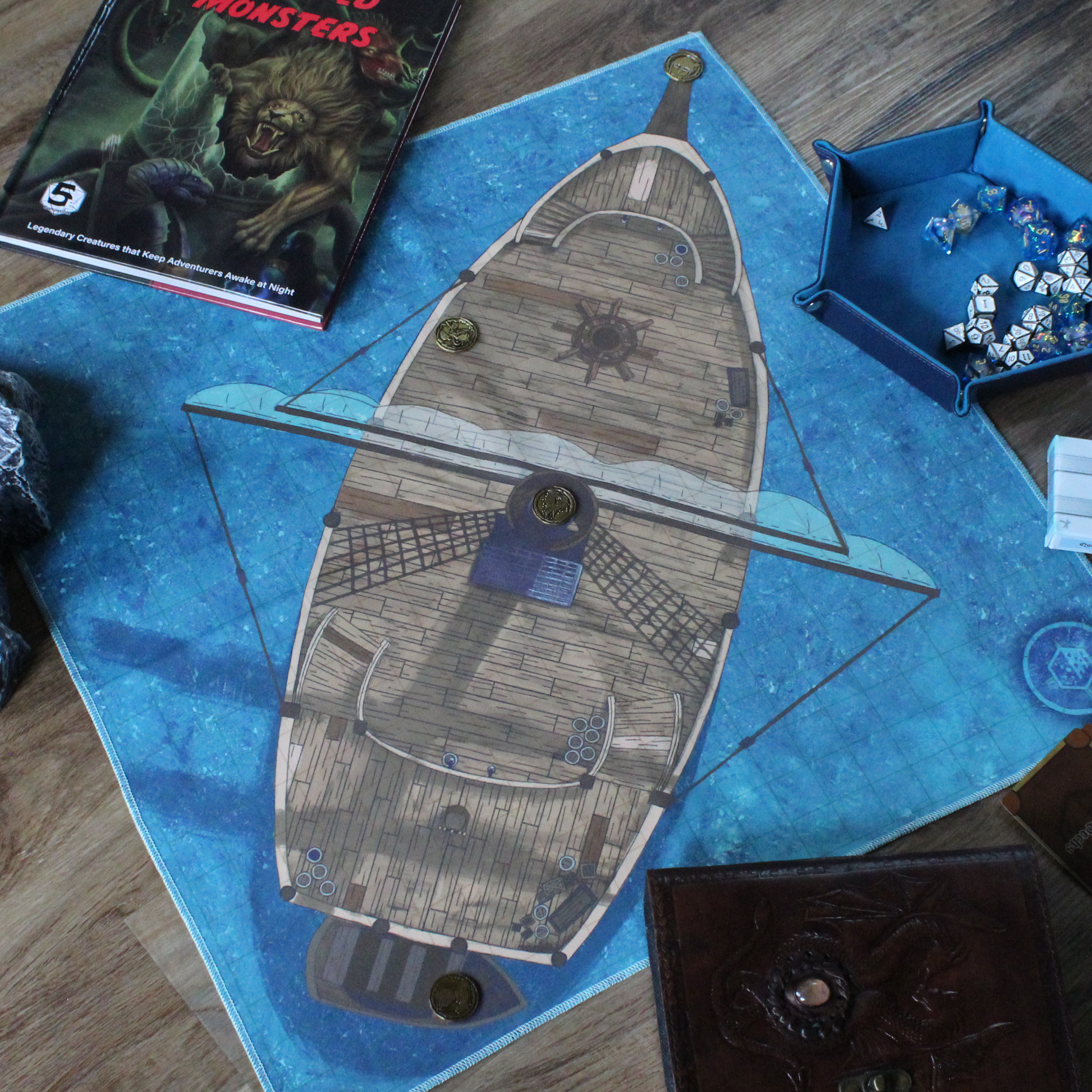 Photo of a battle map depicting a ship with various metal tokens placed on it