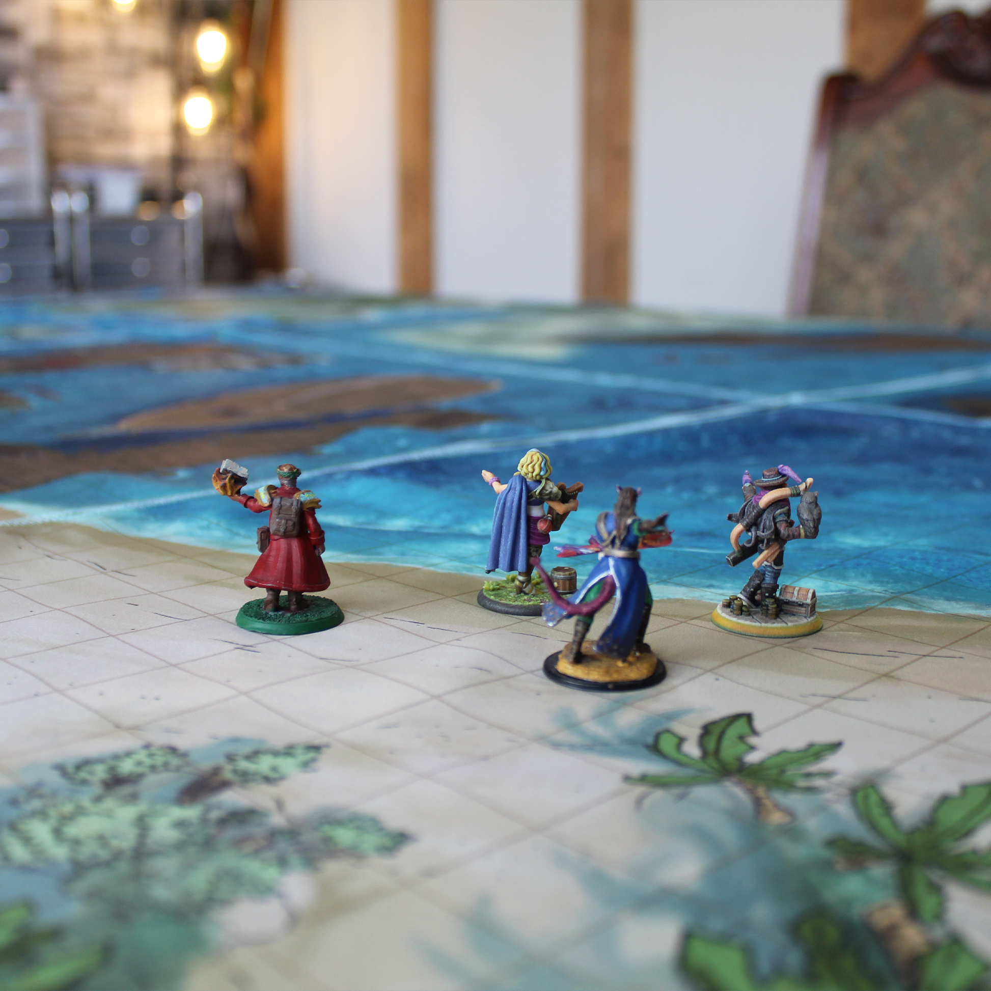 Photo of various miniature figures on a beach battle map