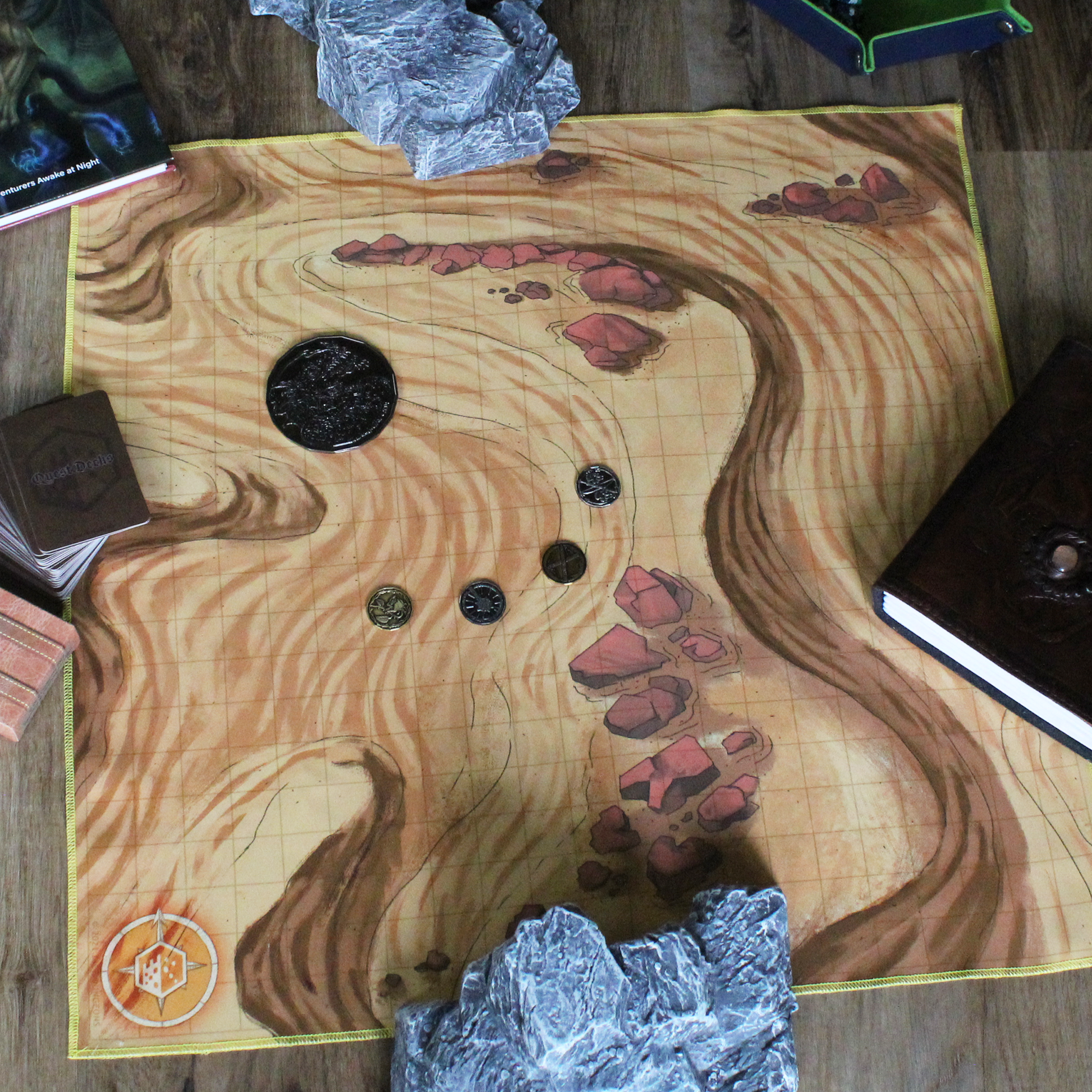 Overhead photo of a desert battle map with various coins on top if it