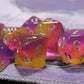 Set of pink and orange polyhedral dice on a textured surface