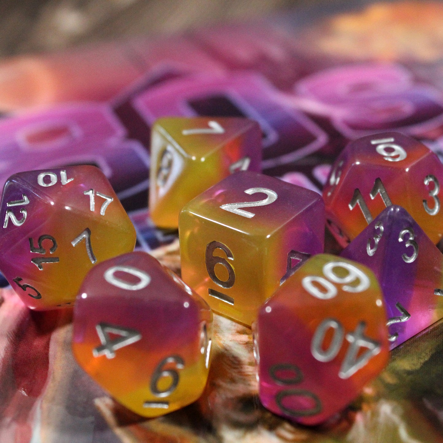 Set of pink and orange polyhedral dice on a colorful background with "80s" written visibly on it