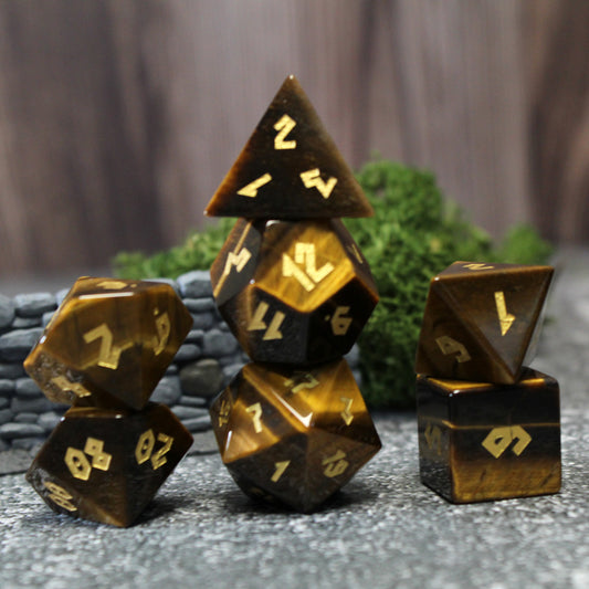 Stacked Tiger Eye dice set showcasing the natural honey, red, and brown stripes with gold numbering on the polished gemstone surfaces.