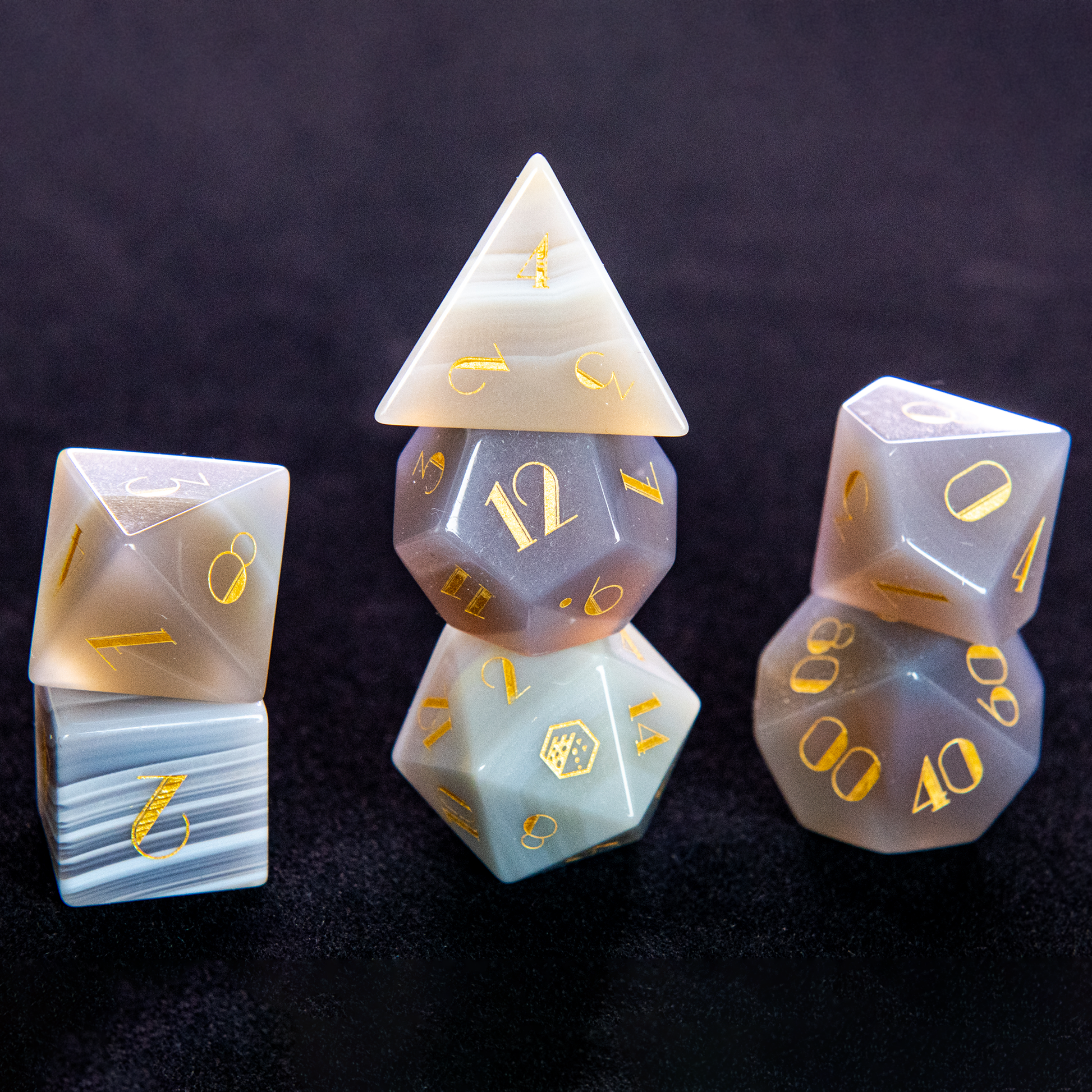 White Stripe Agate dice set with gold numbering, featuring the stone's natural bands of white and translucent layers.