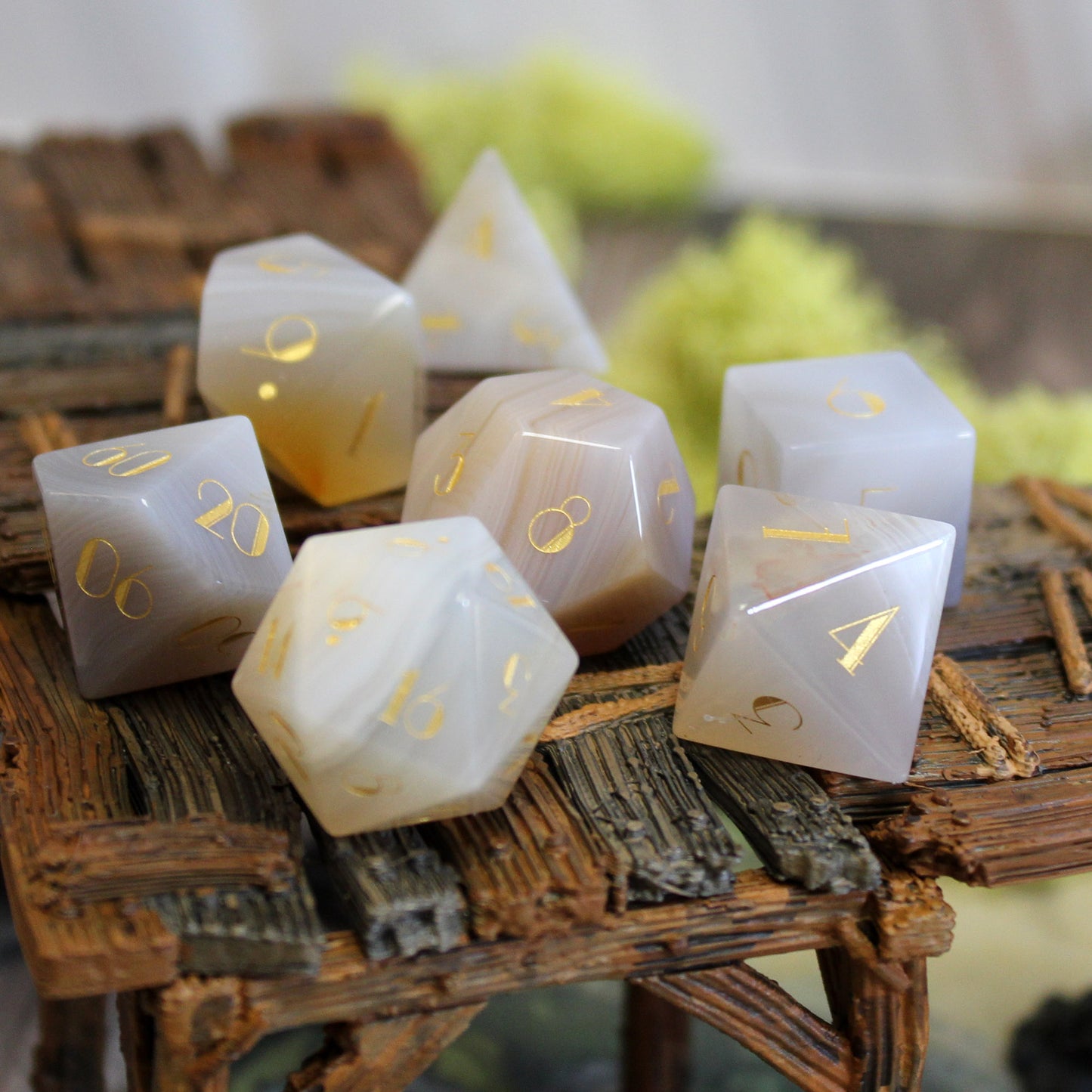 White Stripe Agate Gemstone Dice Set displayed on a DnD game table, adding opulence and style to your RPG sessions with its Roaring Twenties-inspired design.