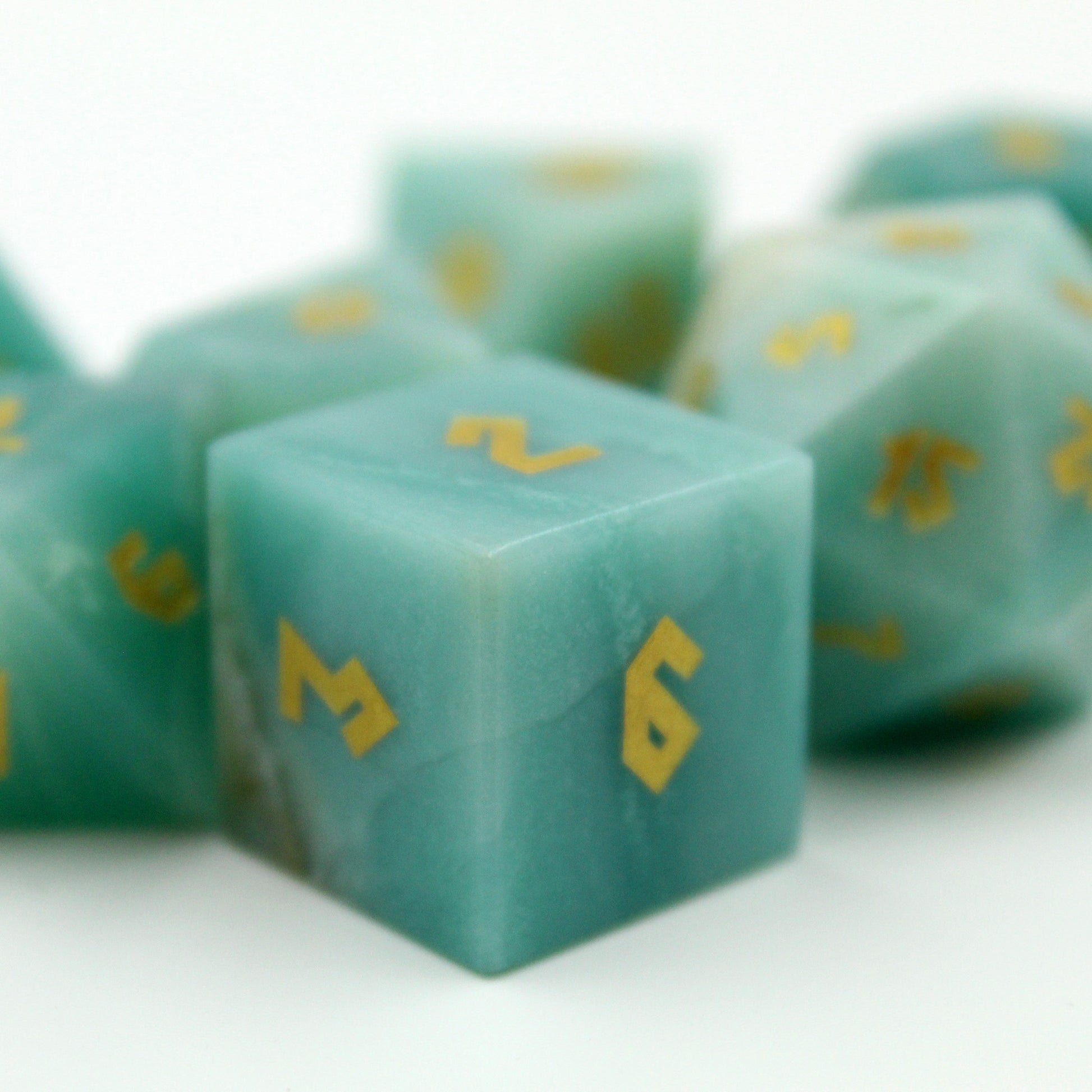 Close-up of the Amazonite d6 die on a white background, highlighting the Grecian-style gold numbering and the smooth finish of the natural gemstone.