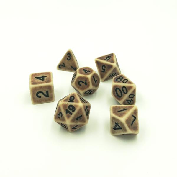 Set of seven plastic rpg dice designed to look like worn brown bone with black numbering on a white background