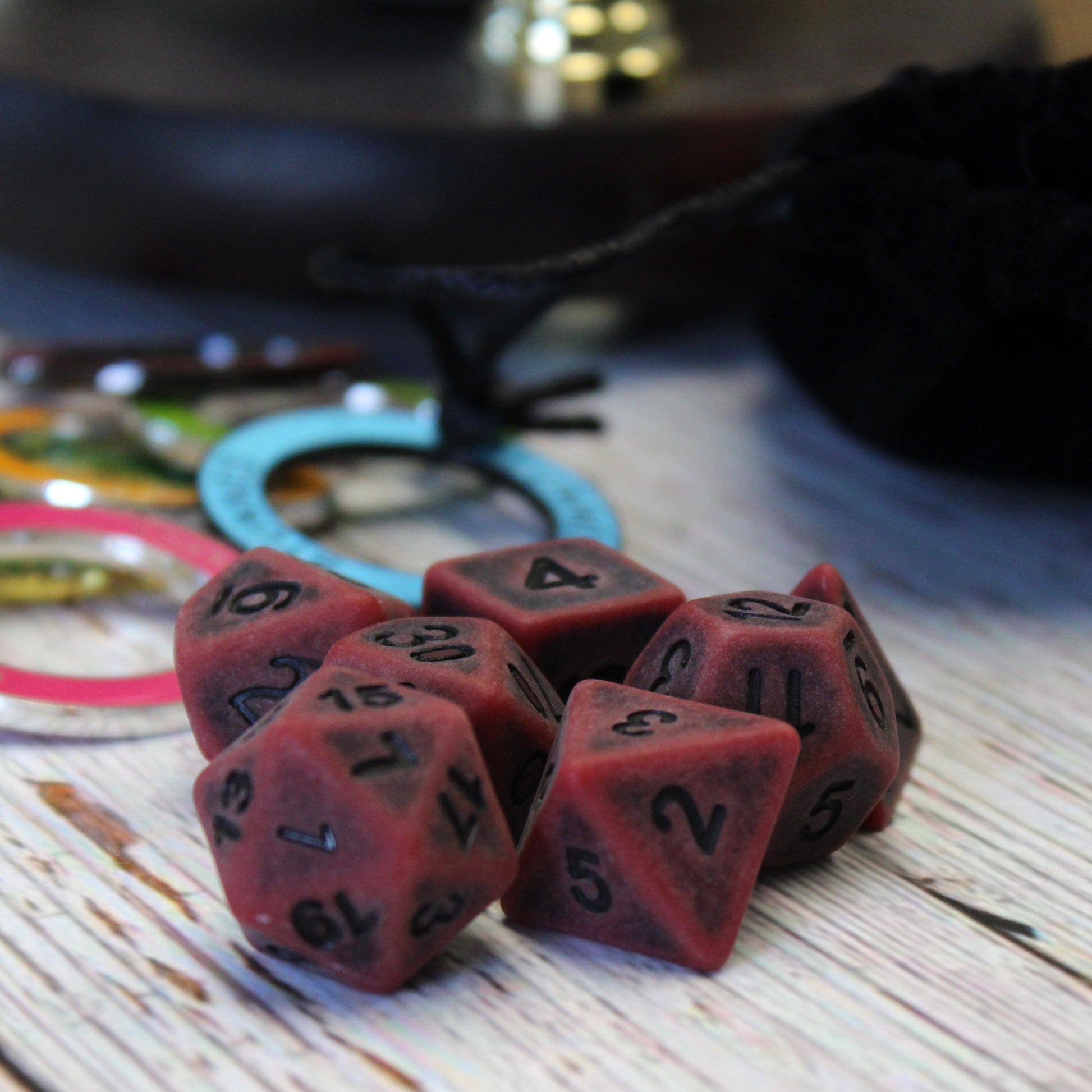 Ancient Red Polymer Dice set on DnD table.