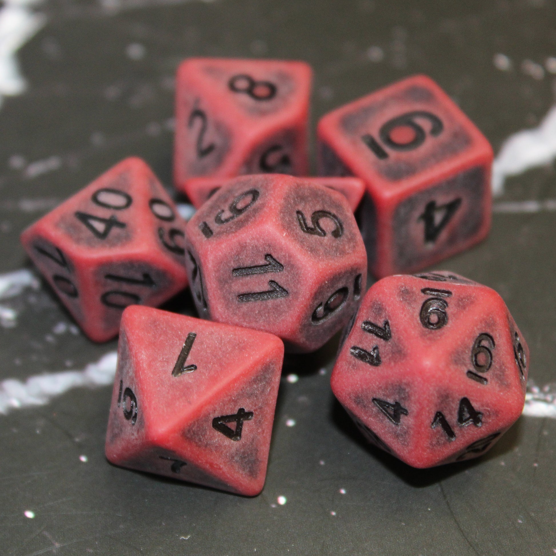 Closeup of our Ancient Red Plastic Dice set for dungeons and dragons gaming.