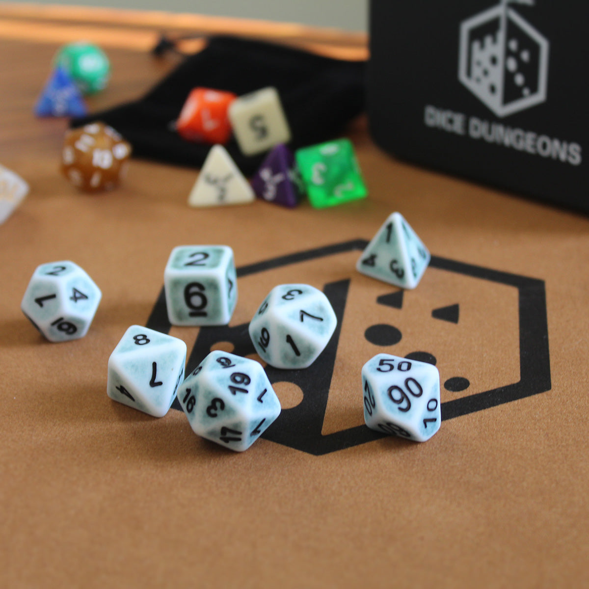Light blue and white antiqued dice sets from dice dungeons.