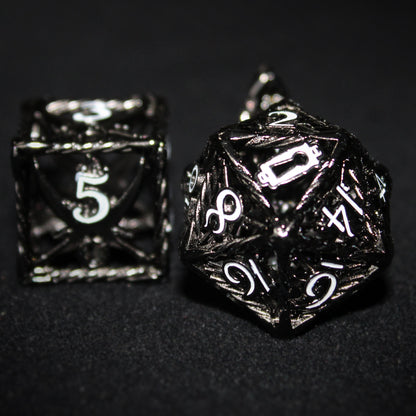 Black D20 and D6 Rogue Cage dice on a black background. The D6 is on the left with the white 5 facing forward, and the D20 is on the right with the white keyhole facing forward, replacing the 20. 