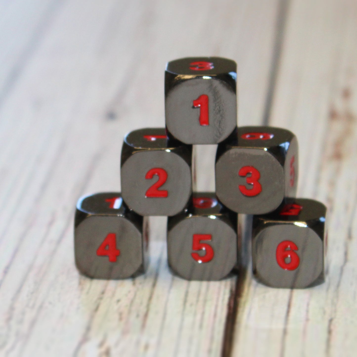 6d6 black nickel dice with red numbers.