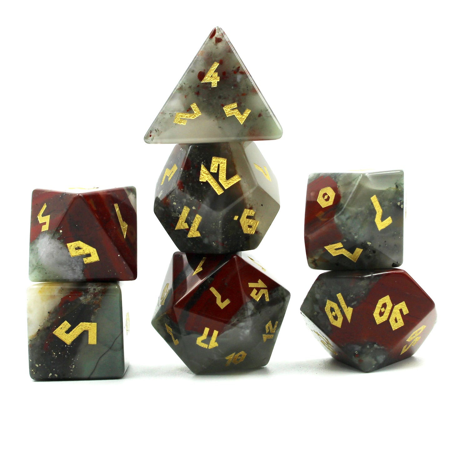 Stacked Bloodstone dice set, highlighting the deep green-gray chalcedony, red hematite spots, and gold leaf numbering on each die.