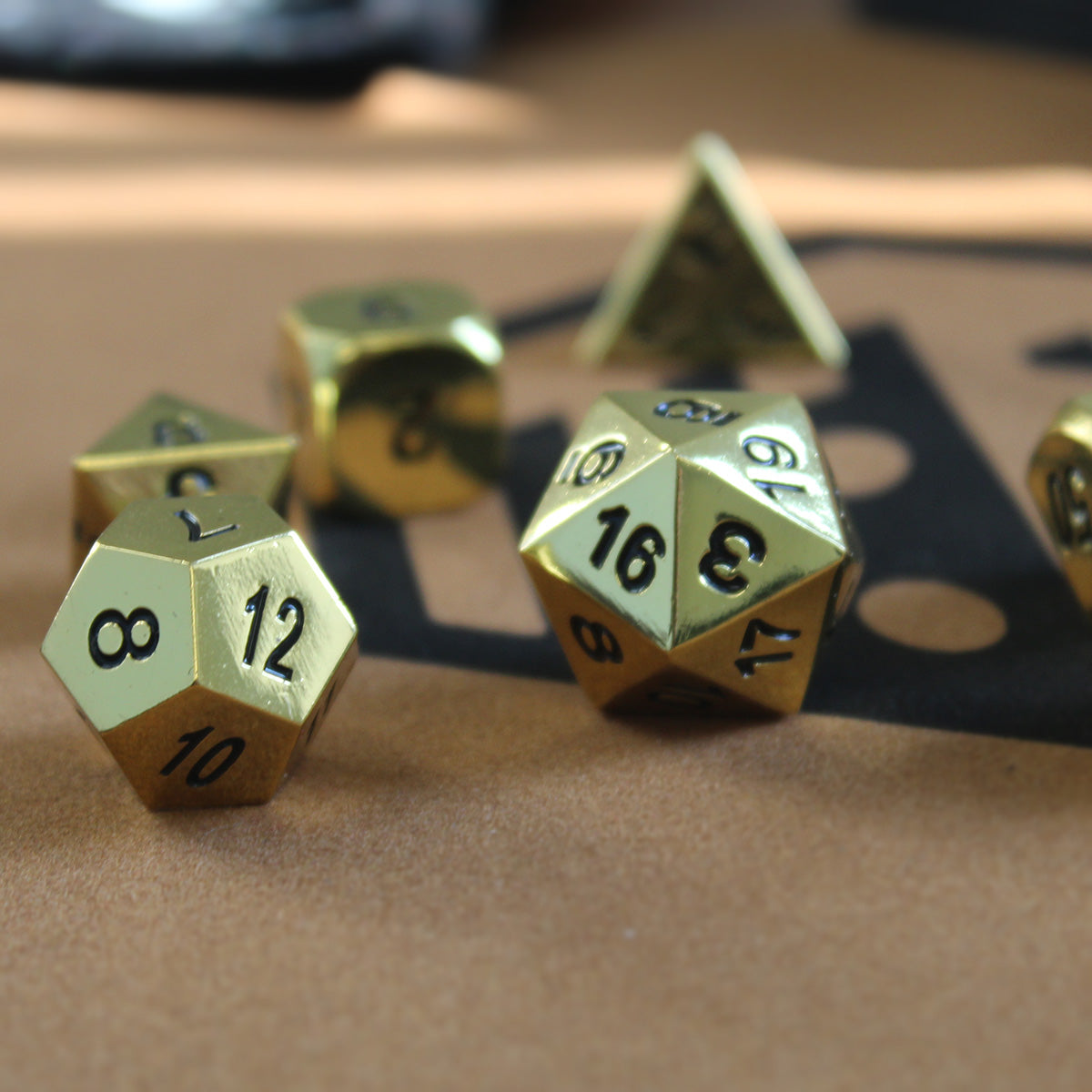 Bright gold metal dice set - closeup.