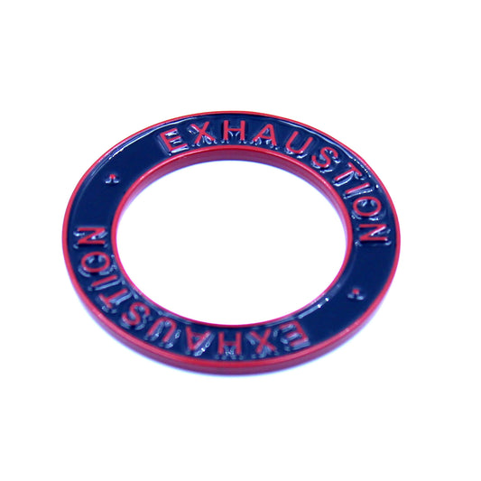 Closeup of a black ring with a red rim and red text that says "Exhaustion" on it 