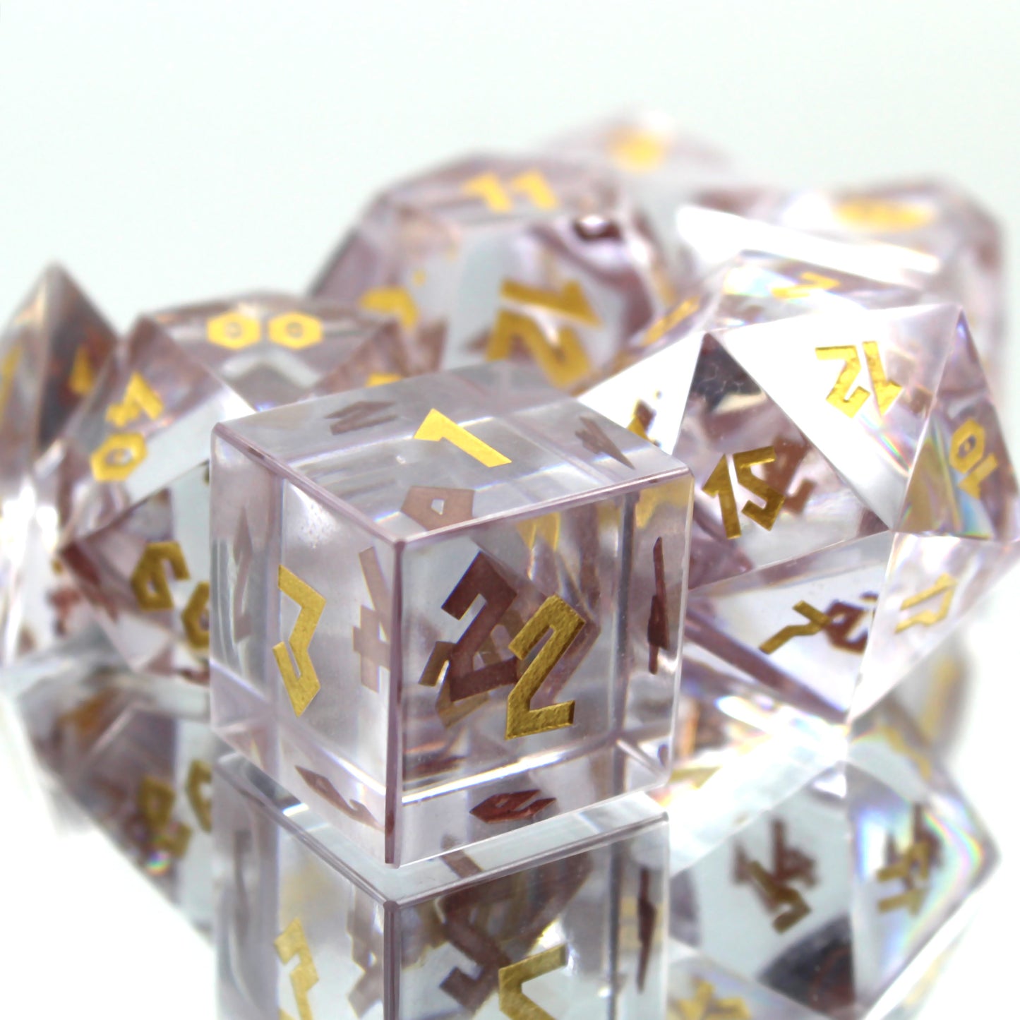 Zoomed in picture of the Cubic Zirconia dice set on a reflective surface and white background with the d6 in the foreground with the 1, 2, and 3 faces towards the viewer.