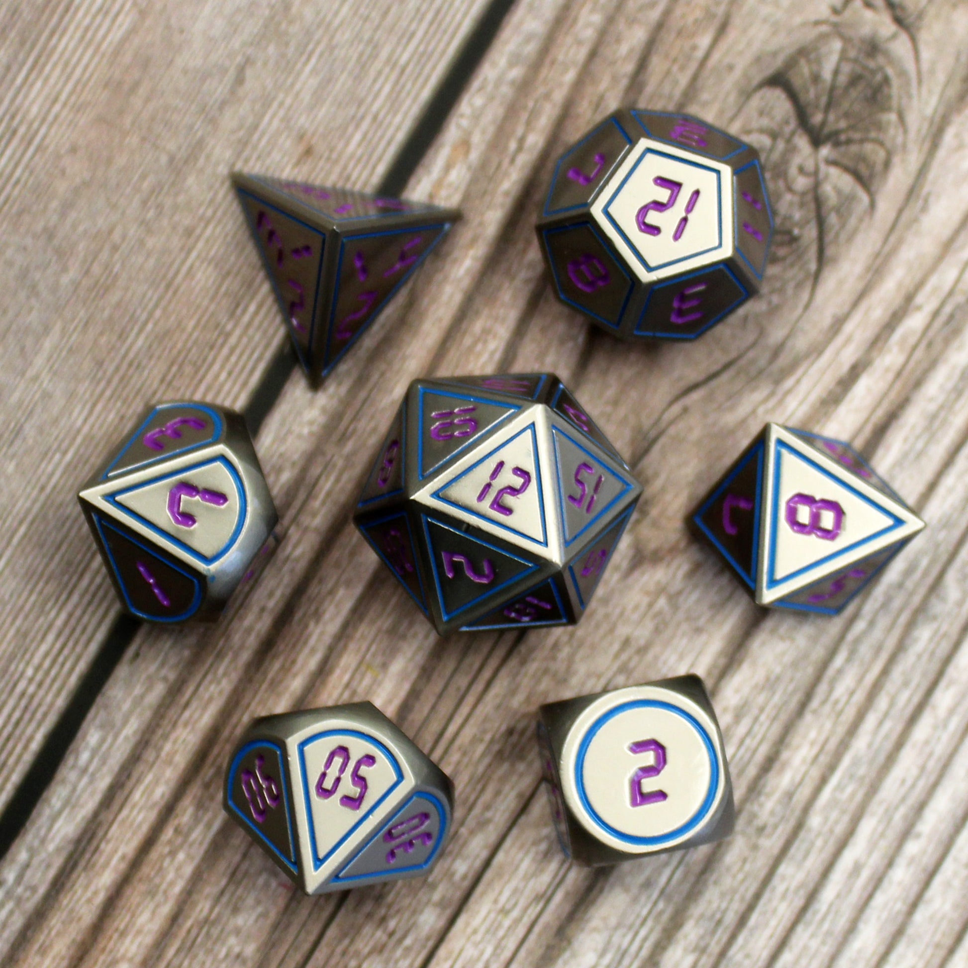 metal dungeons and dragons or starfinder dice on wooden table.