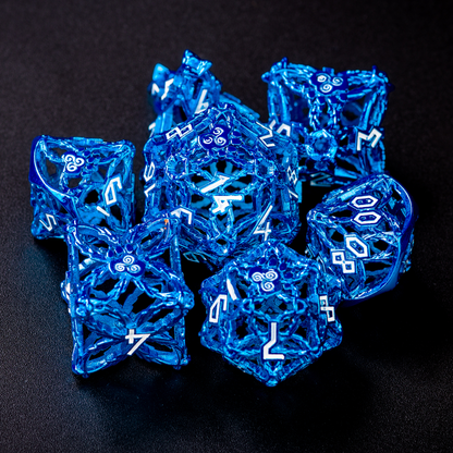 Set of blue druid-inspired hollow metal RPG dice with white numbers and a glyph-covered paw in place of the high number on a black background