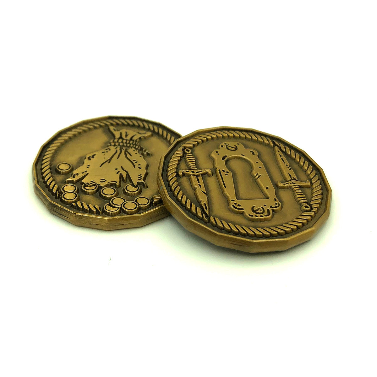 Two golden Rogue character tokens on a white background, showing both the top (depicting a lock and two daggers encircled by a rope) and the bottom (depicting a ripped treasure bag scattering coins encircled by a rope)