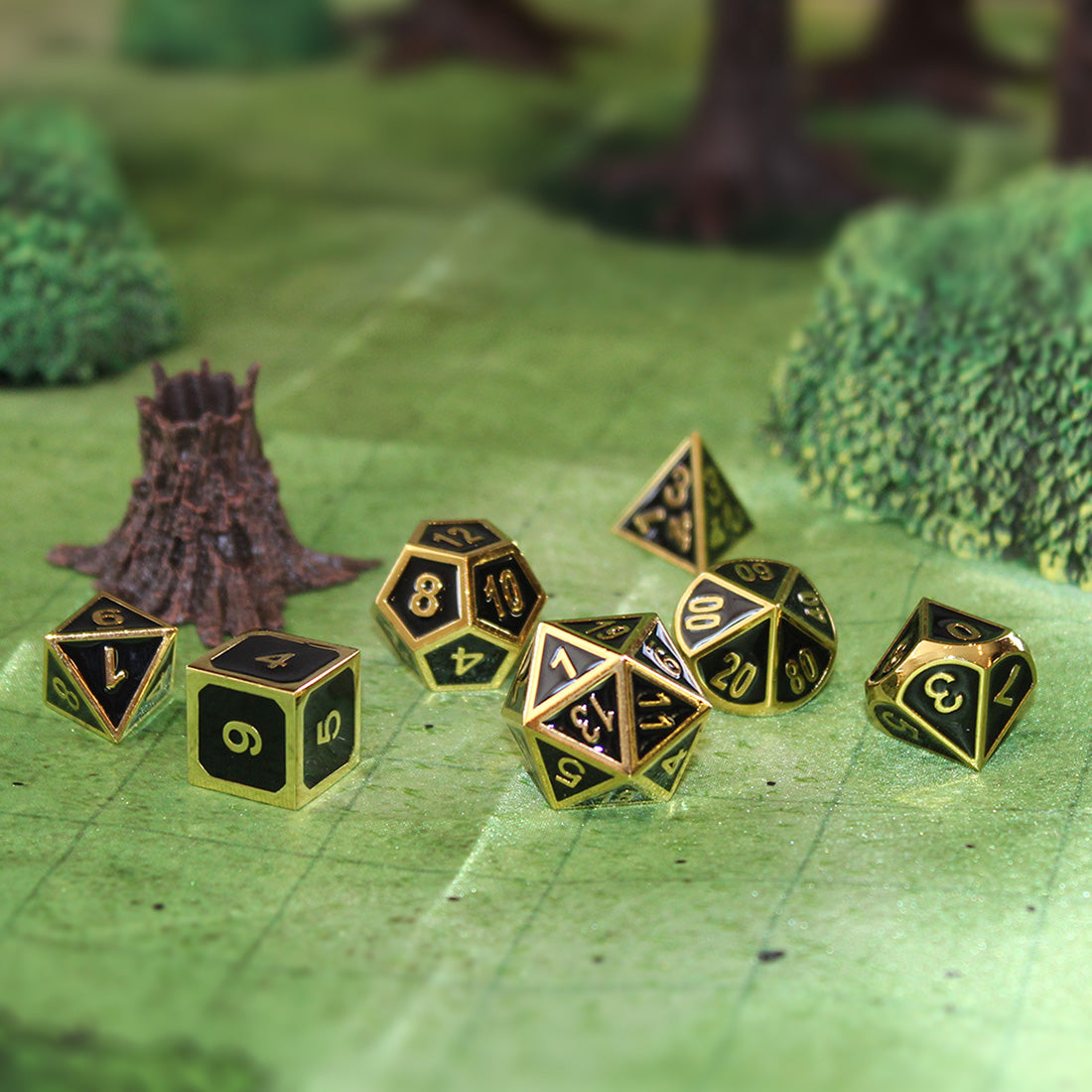 Black and gold metal dice on forest map.