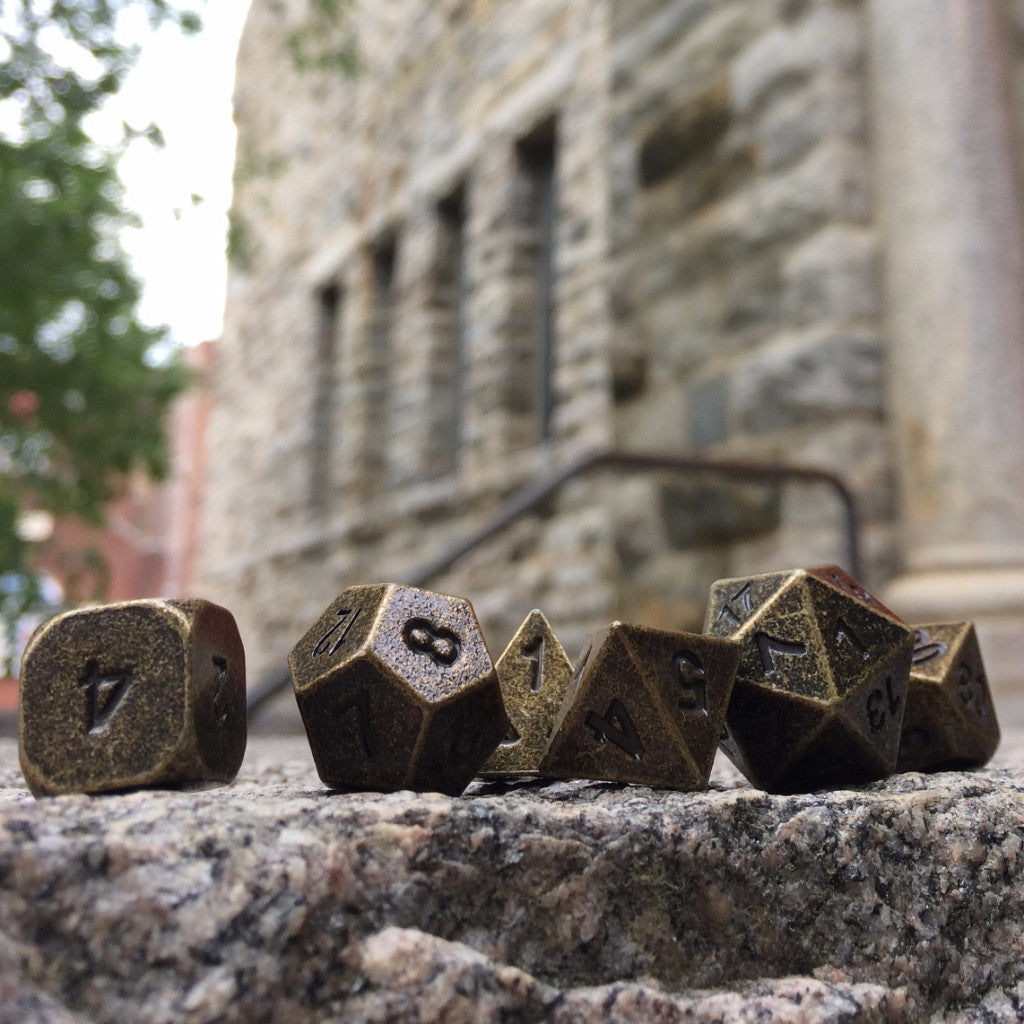 Metal Primordial Gold Dice Set Outside on Stone
