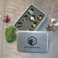 black and gold metal dice in a box.