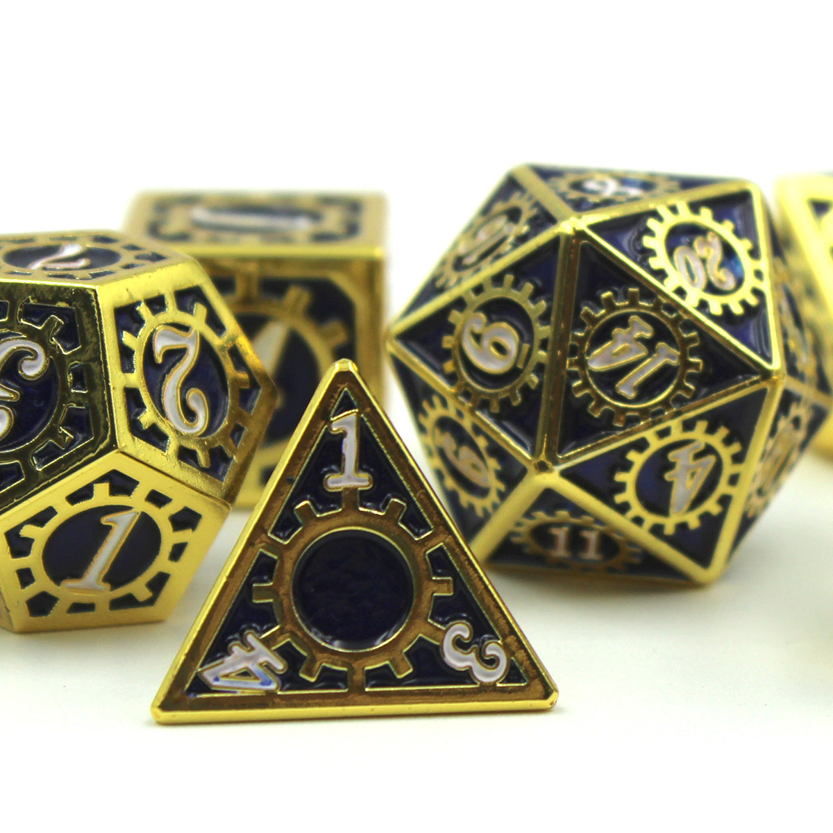 Detail shot of the Mechanist Blue and Gold RPG dice set featuring the d4 with the 1 face presenting resting on white background and surface.