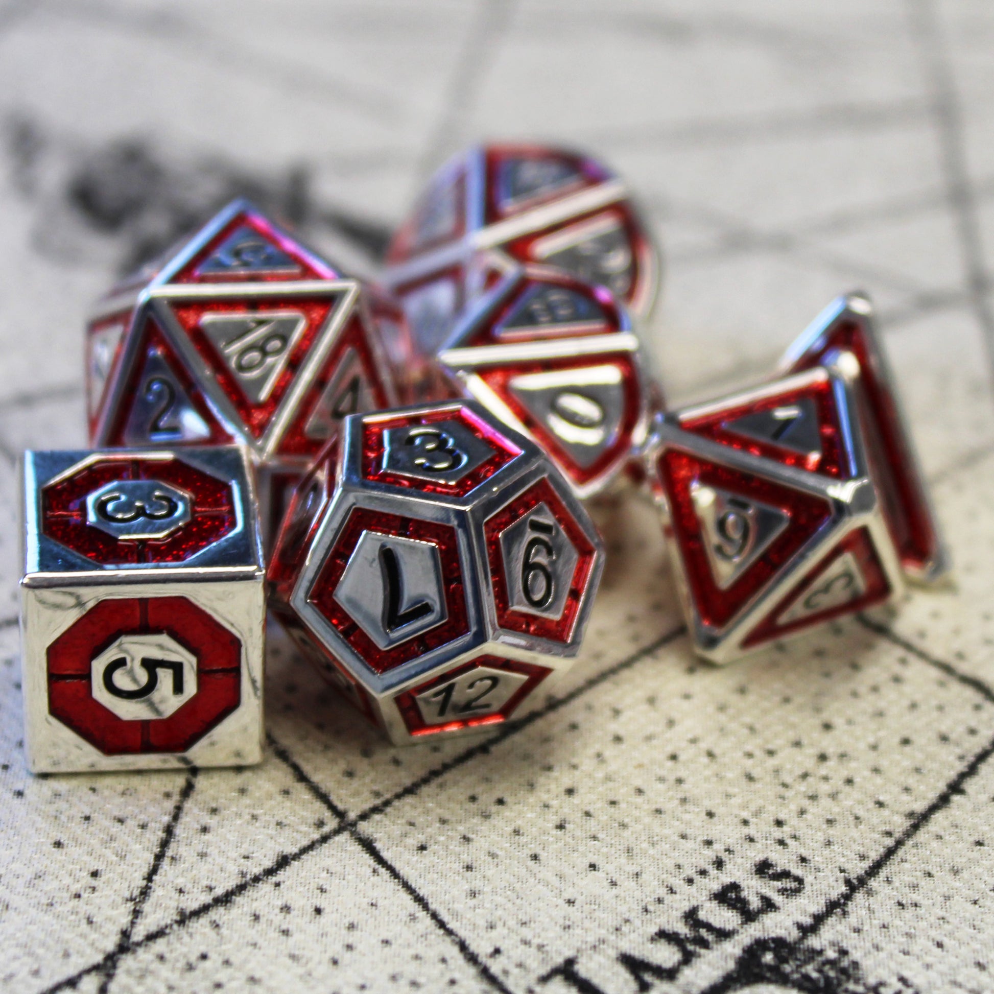 Metal BullsEye red dice set arranged on top of a beige play mat