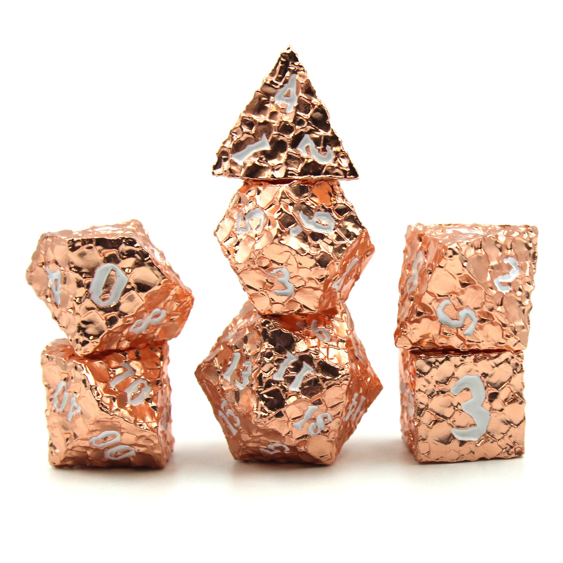 Geomancer Copper dice set arranged in 3 stacks on a white background and surface highlighting the reflective finish of the dice.